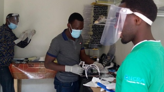 Global Auto Systems (GAS) team members making face shields